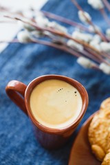 A cup of espresso on a table with cookies