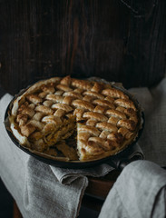 Chicken pie closeup on the black table. Rustic Provence style