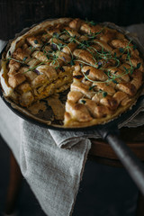 Chicken pie closeup on the black table. Rustic Provence style