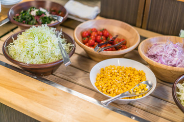 Salads on buffet table at restaurant .