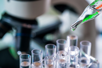 Science laboratory research and development concept. microscope with test tubes