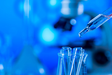 Science laboratory research and development concept. microscope with test tubes