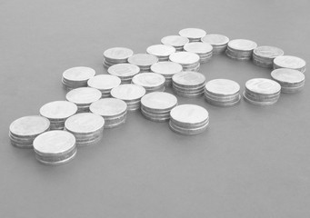 A sumbol of the Russian ruble from coins. Stacks of coins. Black and white concept.