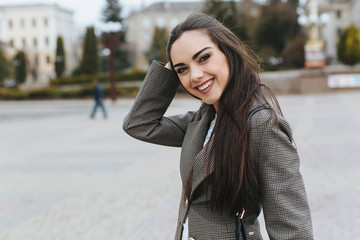 Business woman walking on a street.