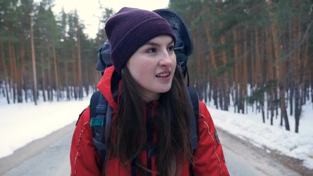 Close-up. Young Hiker female Backpack Walking on a empty road. Slow motion. HD.