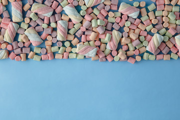 Colorful mini marshmallows background frame. Copy space for text.