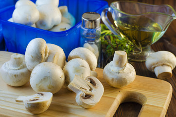 mushrooms champignons on the kitchen board