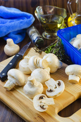 mushrooms champignons on the kitchen board
