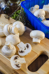 mushrooms champignons on the kitchen board