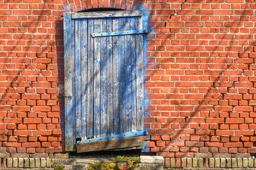 Old blue wooden door and brick wall