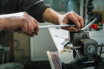 Mechanics repairing a diesel injector.