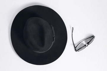 Black hat and black glasses on a white background