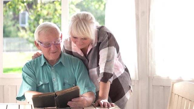 Senior couple reading a book. Man and woman indoor. Never too late to study.