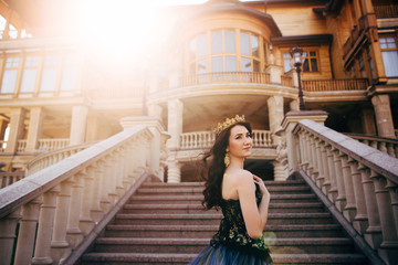 Beautiful woman in a luxurious blue dress with a long train