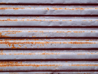 Metallic urban colored texture with rust. Horizontal pattern in the form of strips, blinds