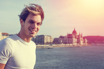 Young blonde man with Budapest background vintage style