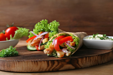Tasty kebab sandwiches on wooden board