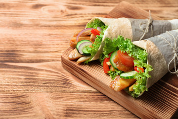 Tasty kebab sandwiches on wooden board