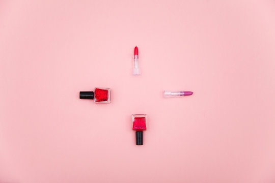 photo of lipsticks and nail polishes on the wonderful pink studio background