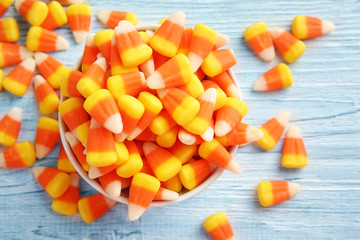 Colorful Halloween candy corns on wooden background