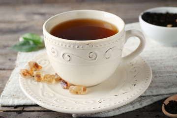 Cup of aromatic tea on napkin