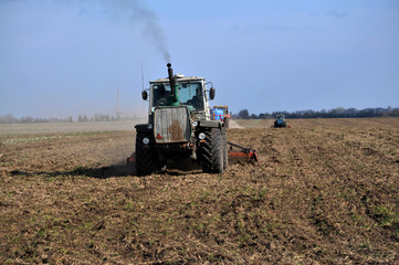 
Tractors prepare the area for planting sugar beets using strips for fine grinding ground