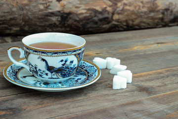 Porcelain cup of tea on a wooden background