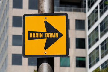 Directional sign with conceptual message BRAIN DRAIN