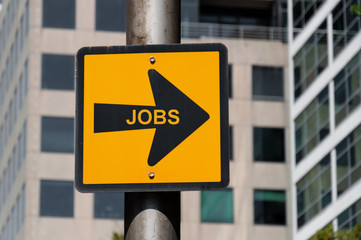 Directional sign with conceptual message JOBS