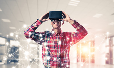 Guy wearing checked shirt and virtual mask demonstrating some em