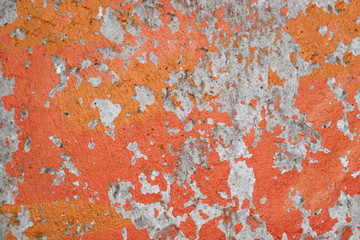 Shabby orange paint from concrete walls