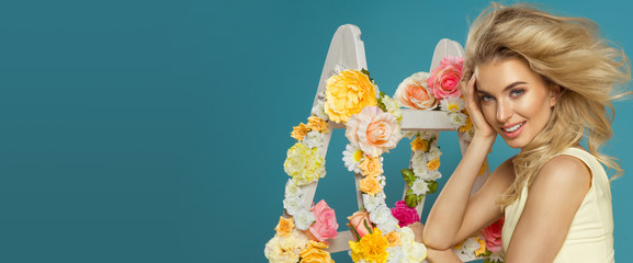 Delicate blonde woman with floral white lAdder