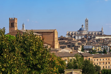 The view of the Basilica di San Domenico and the Cathedral Duomo from the Medici Fortress - Siena, Italy