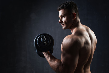 Fototapeta na wymiar Handsome muscular bodybuilder showing his muscles.