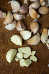 Garlic and garlic press on rustic wooden wooden background