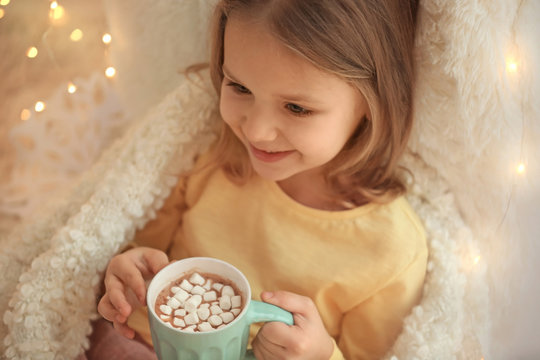 Cute Little Girl Drinking Hot Chocolate With Marshmallow At Home