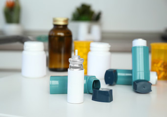 Asthma inhalers and medications on table