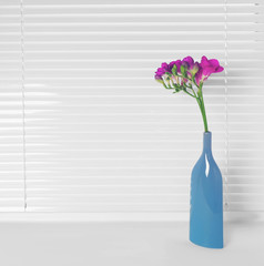 Vase with beautiful flowers on windowsill