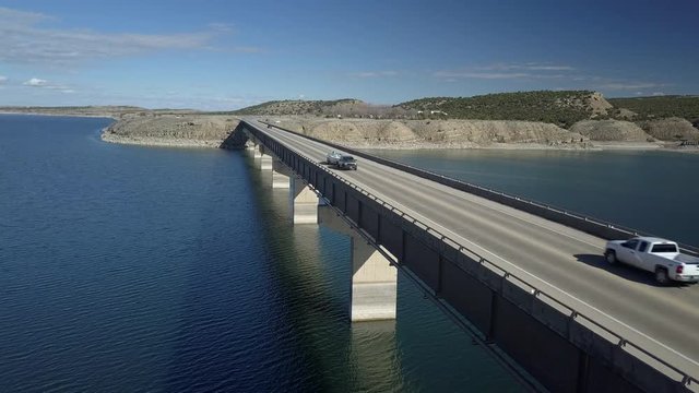 Aerial Starvation Reservoir lake bridge boat trailer travel. State Park open year round for recreation, fishing and boating. Freedom Bridge. Duchesne Utah and Uintah Basin Ute Indian Reservation.