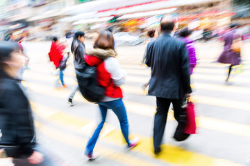 crowd of people crossing a city street