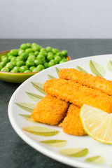 breaded fish fingers with peas