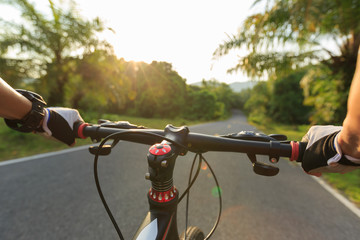 Fototapeta na wymiar cyclist riding mountain bike on tropical forest trail