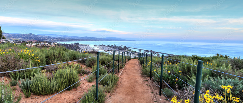 Wall mural Hiking trail above Dana Point city view at sunset