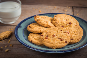Raspberry cookies on plate and milk glass