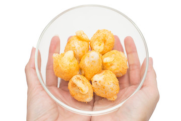 Cheese ball in glass bowl on two hands.