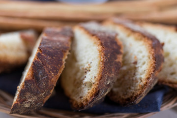 Freshly baked sliced bread on rustic wooden table, close up of brown bread.