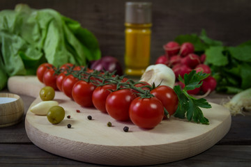 Fresh cherry tomatoes on a kitchen board