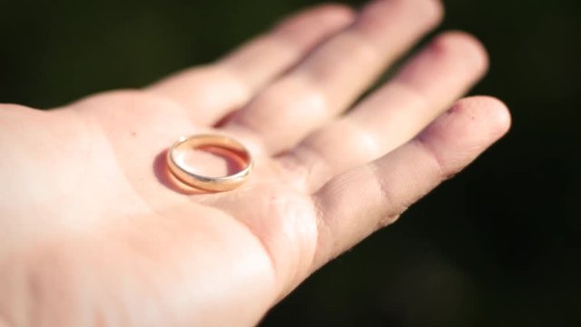 Man proposes - Close up of gold ring in sunlight