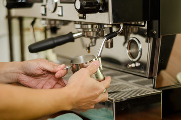Cropped Hand Of Worker Pouring Coffee Into Cups At Cafe