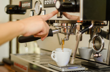 Cropped Hand Of Worker Pouring Coffee Into Cups At Cafe